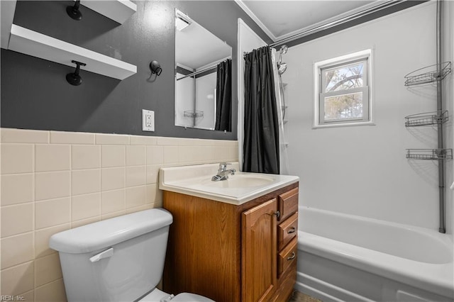 full bathroom featuring vanity, toilet, tile walls, and shower / bath combo