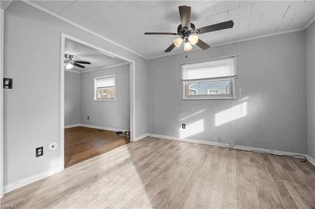 spare room with crown molding, ceiling fan, and light wood-type flooring