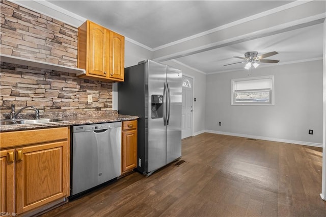 kitchen featuring dark wood-type flooring, sink, crown molding, appliances with stainless steel finishes, and ceiling fan