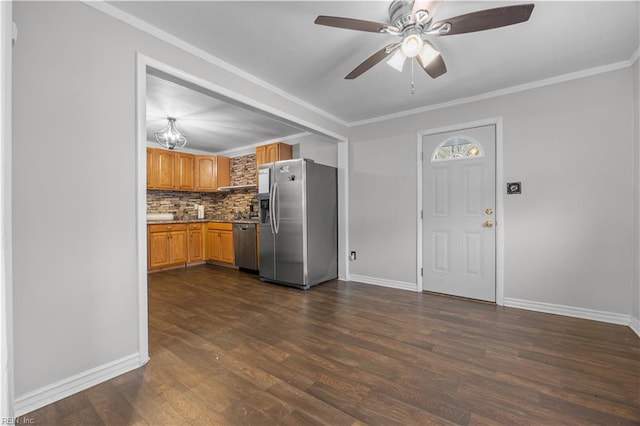 kitchen with ceiling fan, backsplash, stainless steel appliances, ornamental molding, and dark hardwood / wood-style flooring