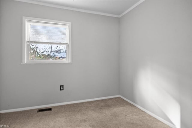 empty room with ornamental molding and light carpet