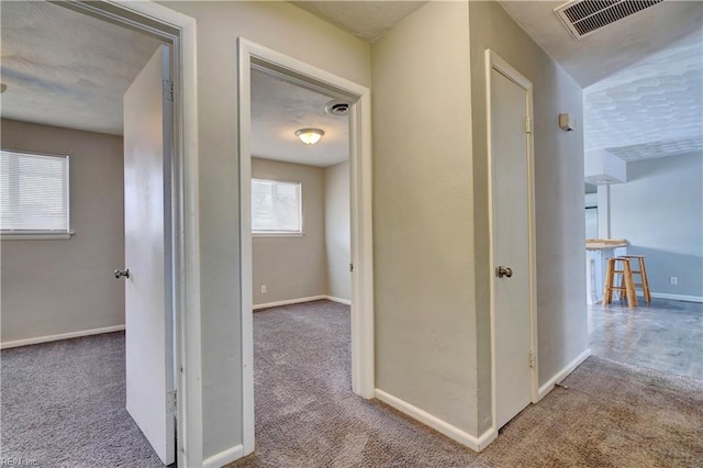 hallway with light colored carpet