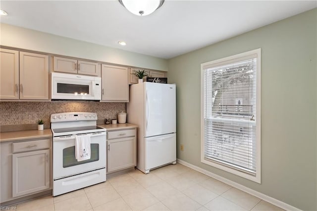 kitchen with tasteful backsplash, white appliances, and light tile patterned flooring