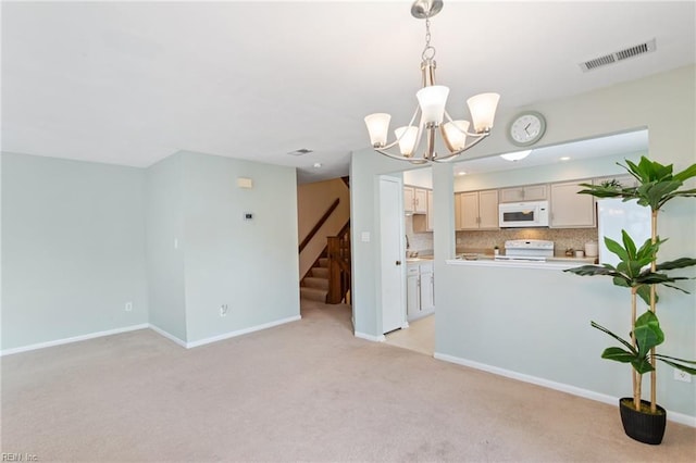 kitchen with a chandelier, light carpet, hanging light fixtures, electric range, and decorative backsplash