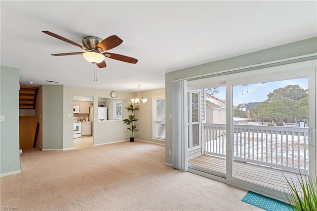 interior space featuring ceiling fan with notable chandelier