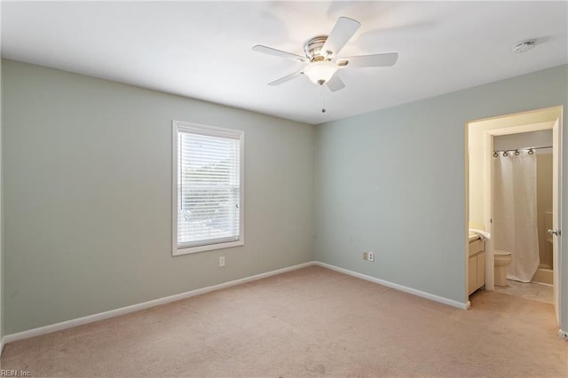 empty room with ceiling fan and light colored carpet