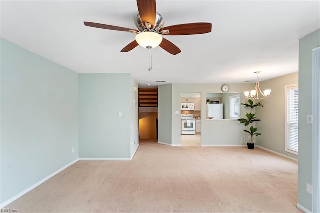 unfurnished living room with light carpet and ceiling fan with notable chandelier