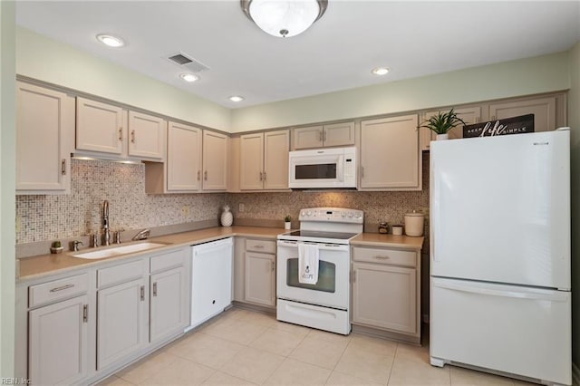 kitchen featuring backsplash, white appliances, sink, and light tile patterned floors