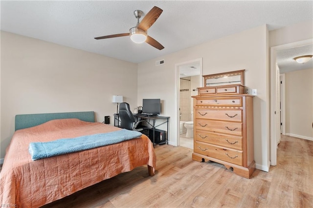 bedroom featuring ceiling fan, ensuite bath, and light hardwood / wood-style flooring