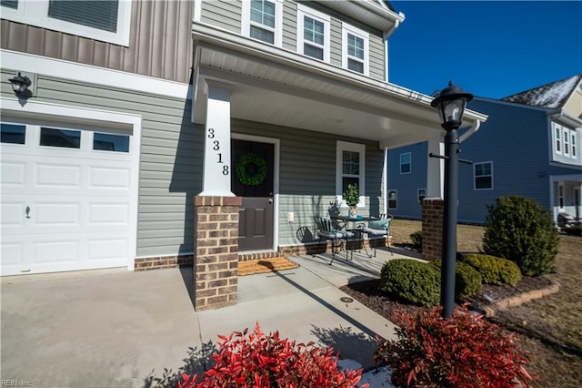 entrance to property with a garage and covered porch