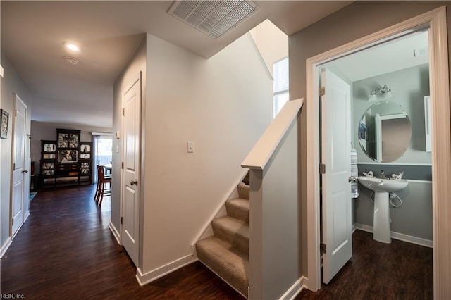 hallway with dark hardwood / wood-style flooring