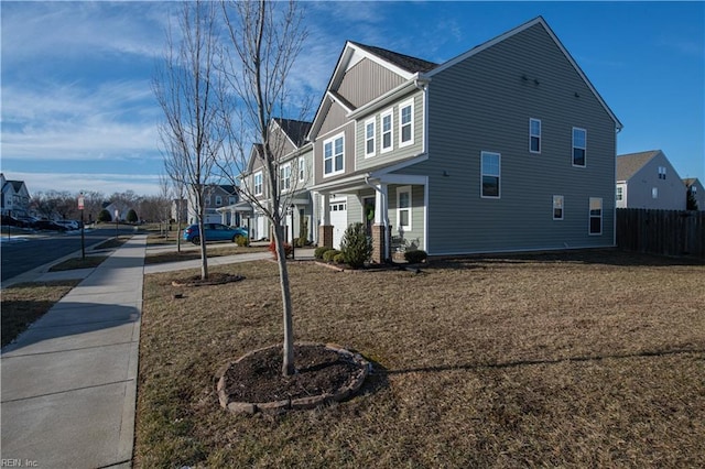 view of side of home with a yard