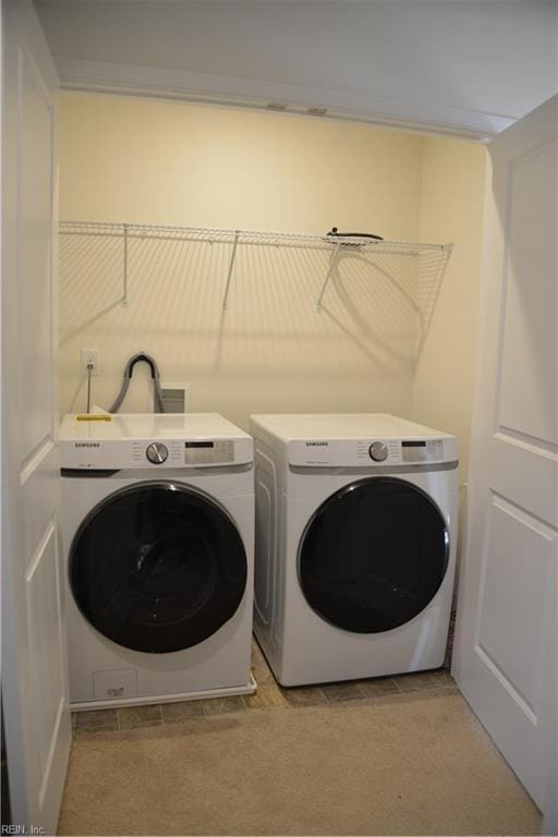 laundry room with light carpet and washing machine and clothes dryer