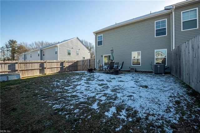 snow covered property with cooling unit