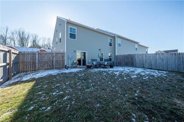 rear view of house featuring a patio area, central air condition unit, and a lawn