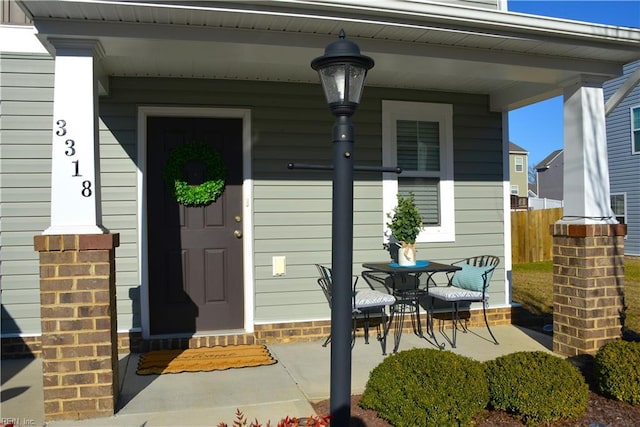 view of exterior entry with covered porch