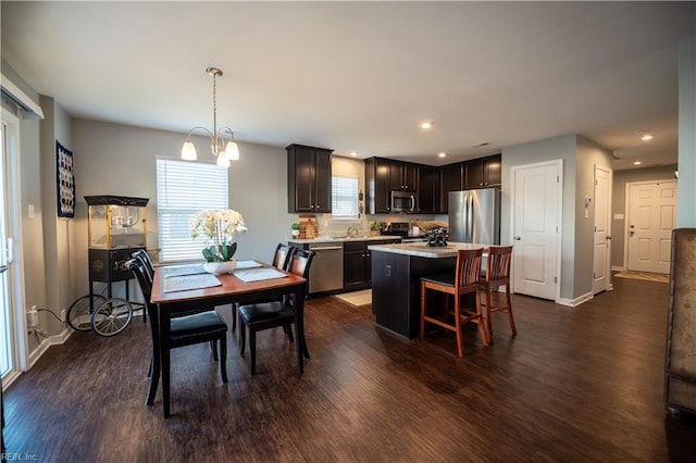 dining space with dark hardwood / wood-style floors