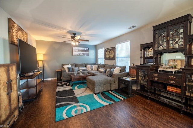 living room with dark wood-type flooring and ceiling fan