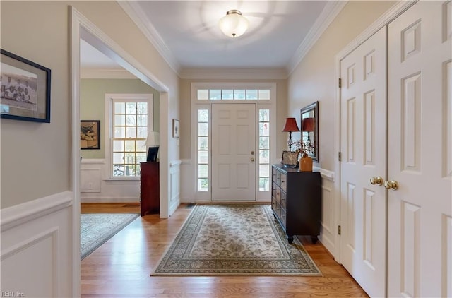 entryway with crown molding and light wood-type flooring