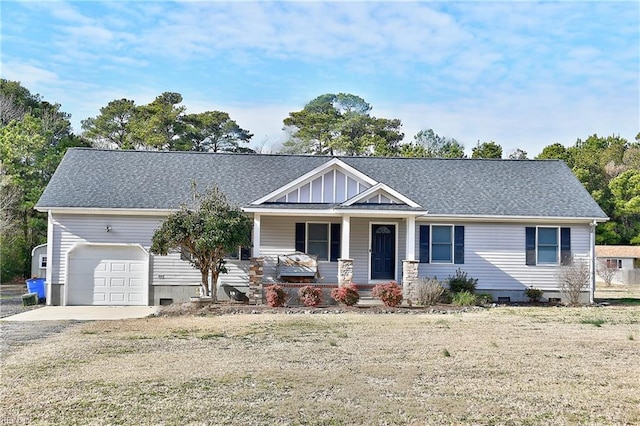 view of front of home featuring a garage, a front yard, and covered porch