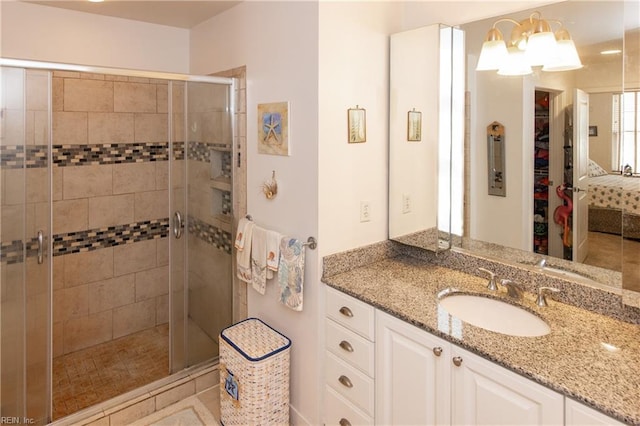 bathroom featuring vanity and a shower with shower door