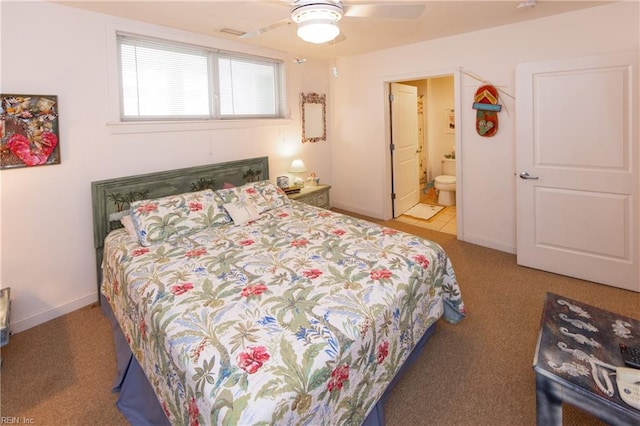 bedroom with light colored carpet, ceiling fan, and ensuite bathroom