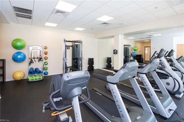 gym featuring a drop ceiling