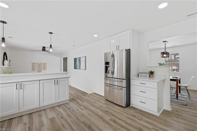 kitchen with decorative light fixtures, light hardwood / wood-style floors, white cabinets, and stainless steel refrigerator with ice dispenser