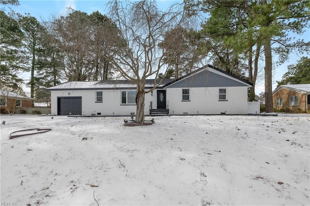 snow covered property featuring a garage