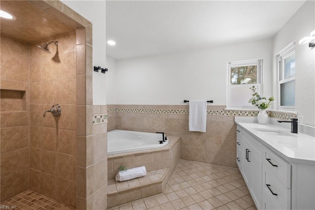 bathroom with tile patterned flooring, vanity, independent shower and bath, and tile walls