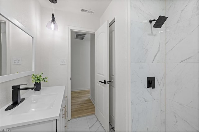 bathroom featuring vanity and a tile shower