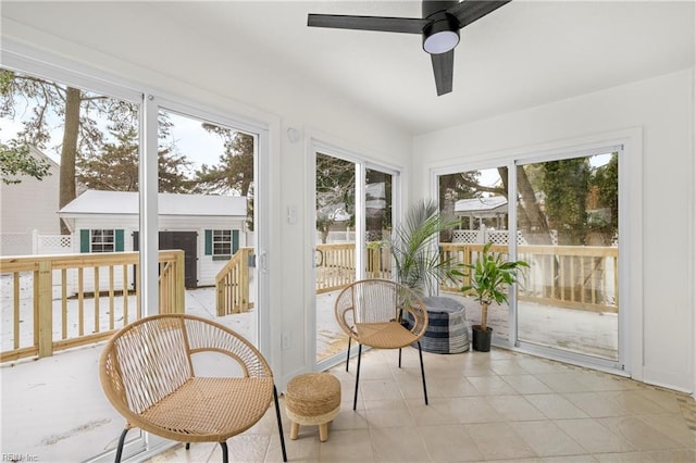 sunroom / solarium featuring ceiling fan