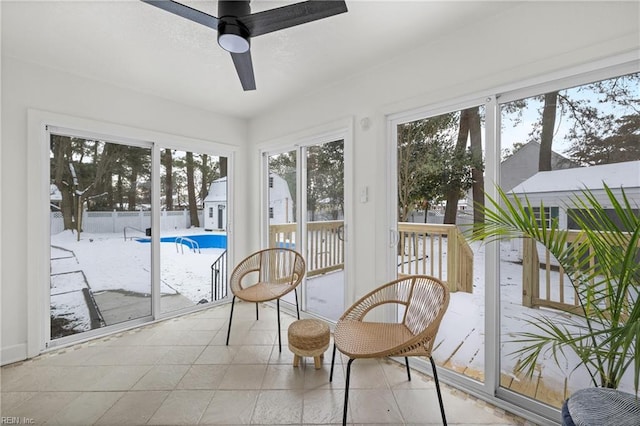 sunroom with ceiling fan and a wealth of natural light