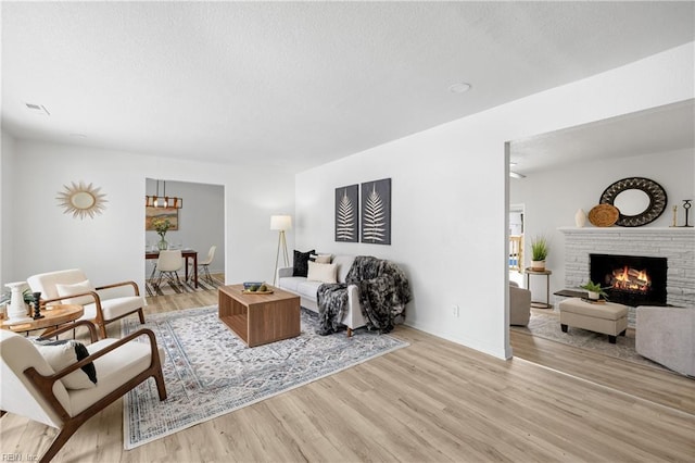 living room featuring a fireplace and light hardwood / wood-style floors