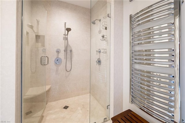 bathroom with walk in shower and radiator heating unit