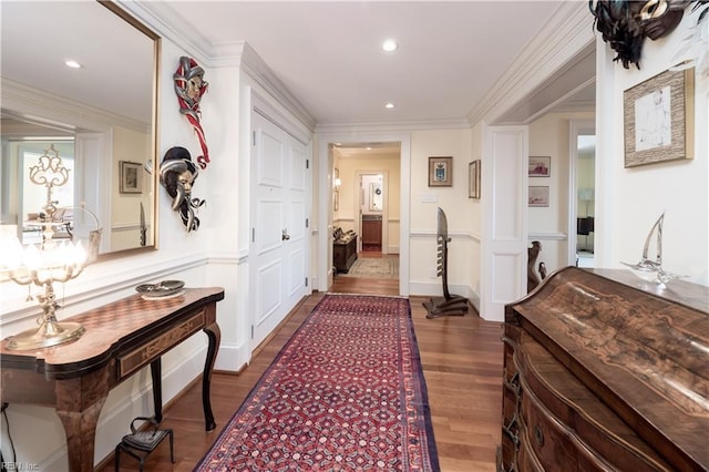 hallway with dark hardwood / wood-style flooring and ornamental molding