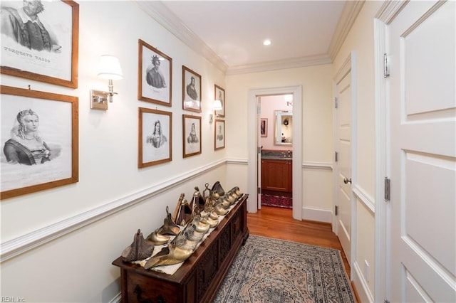 corridor with hardwood / wood-style flooring and ornamental molding