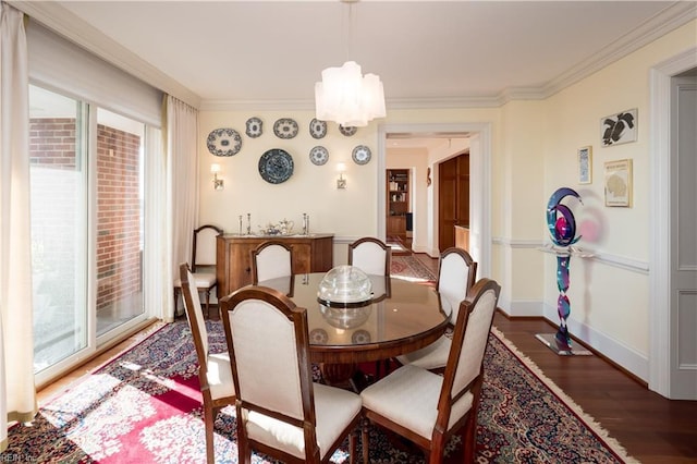 dining area with crown molding, dark hardwood / wood-style flooring, and a wealth of natural light