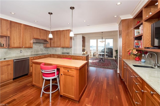 kitchen featuring wood counters, tasteful backsplash, sink, a center island, and stainless steel dishwasher