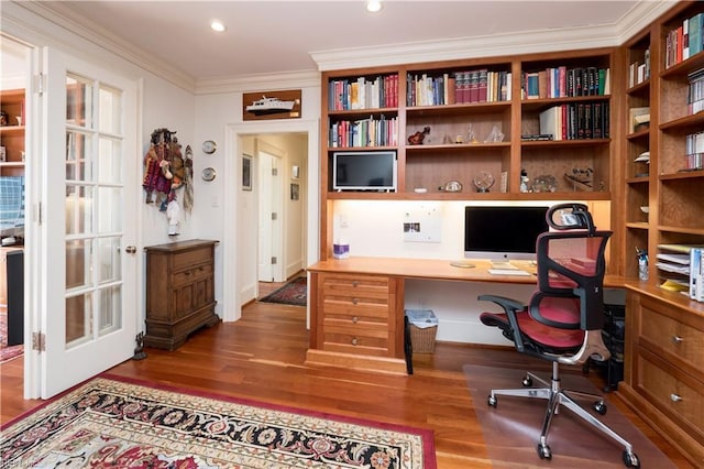 office with crown molding, hardwood / wood-style floors, and built in desk