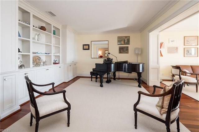 living area with crown molding, dark hardwood / wood-style floors, and built in features