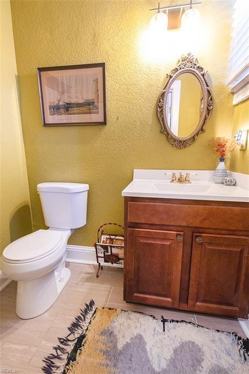 bathroom with vanity, tile patterned floors, and toilet