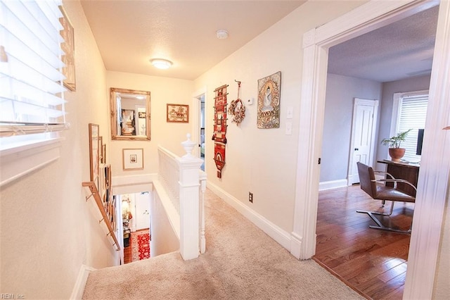 corridor with hardwood / wood-style floors