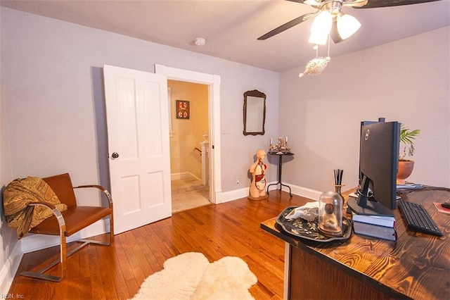 home office with wood-type flooring and ceiling fan