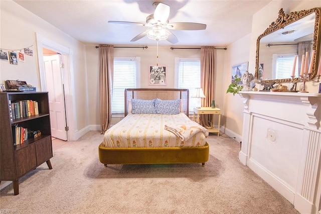 bedroom featuring light colored carpet and ceiling fan