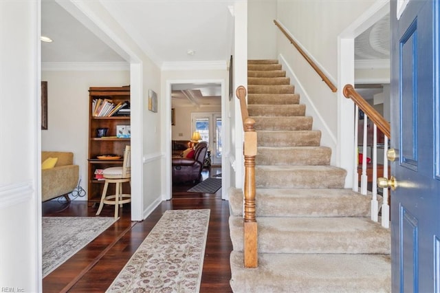 foyer entrance featuring ornamental molding and dark hardwood / wood-style floors