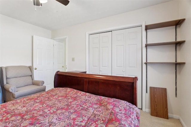 carpeted bedroom featuring ceiling fan and a closet