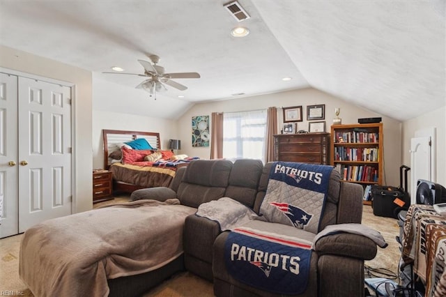 carpeted bedroom featuring ceiling fan, lofted ceiling, and a closet