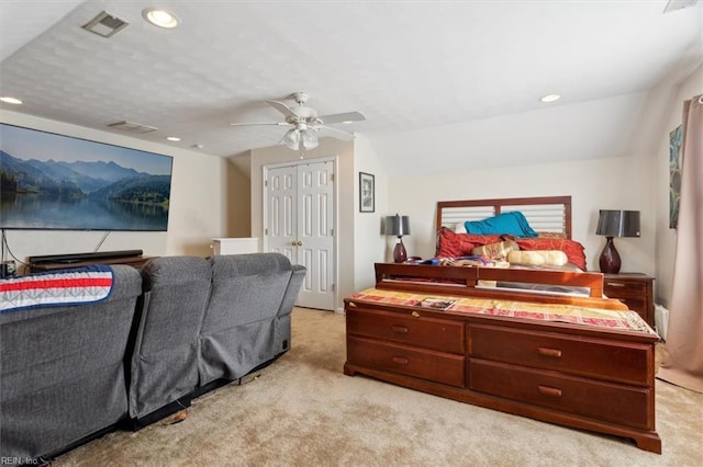 bedroom with lofted ceiling, light colored carpet, ceiling fan, and a closet