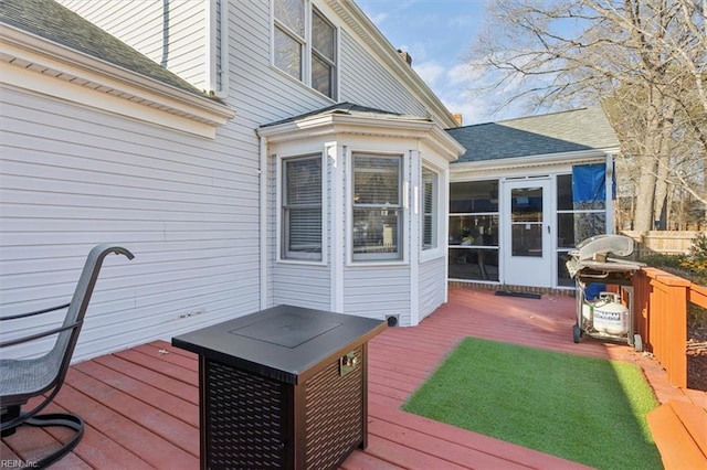 deck featuring a grill and a sunroom